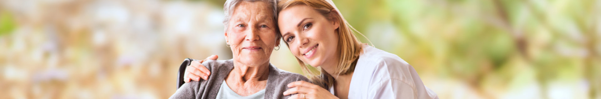 a young lady hugging a senior woman