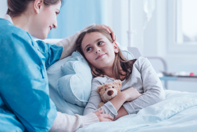 smiling caregiver visiting happy sick child 