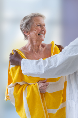 nurse assisting elderly woman for shower